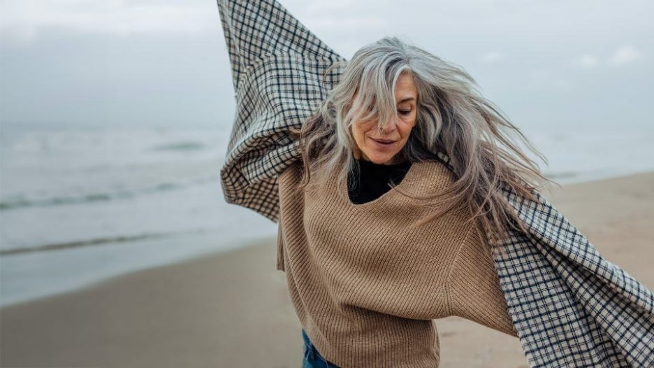 senior woman enjoying a winter day on the beach