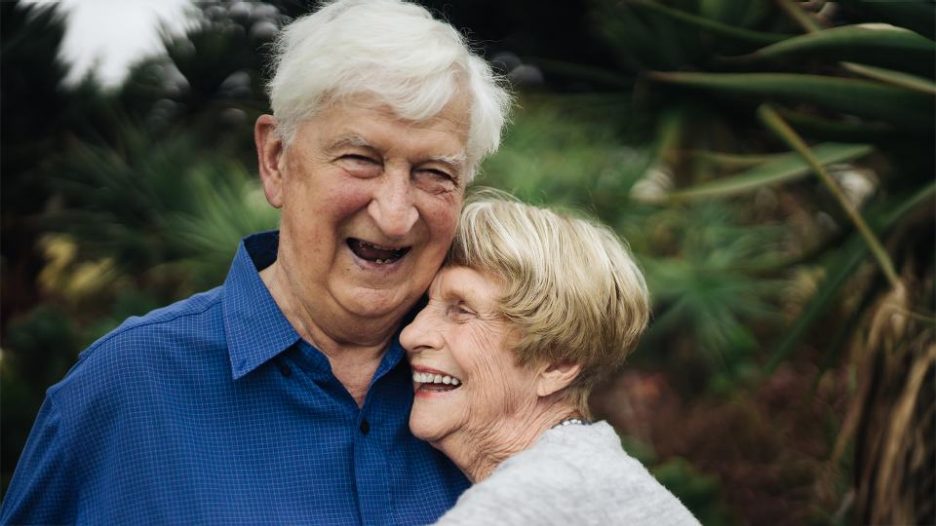 a mature couple lovingly enjoy each others company