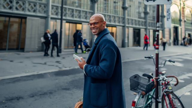 Handsome young businessman walking down the street, going to work