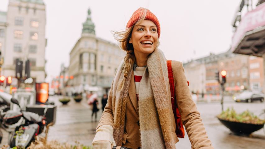 excited happy woman exploring a new city on a cold day