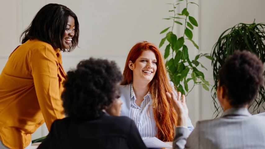 Smiling group of female professionals in meeting