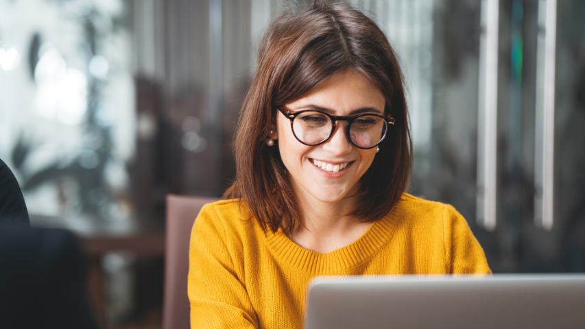 Smiling female looking at computer screen