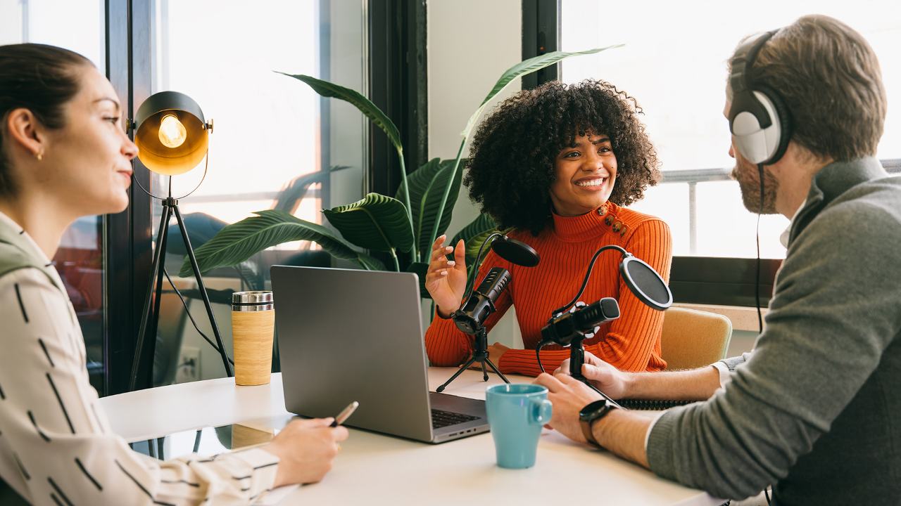 podcast co-hosts engaging in conversation within modern studio