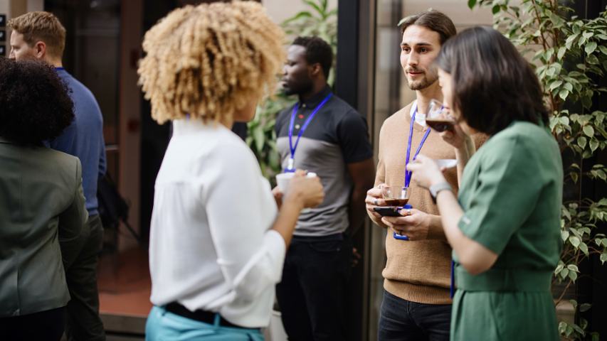 Male and female professionals mingling during coffee break