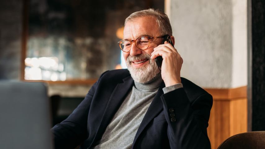  businessman talking phone in cafe