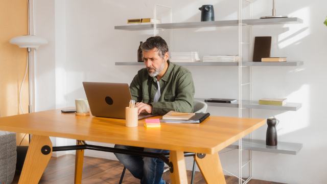 casual dressed man with laptop in home office