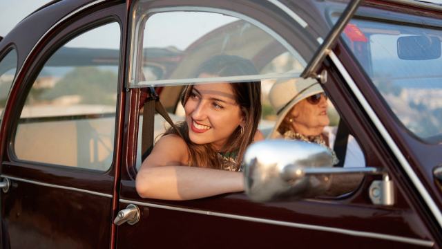 modern grandmother on a road trip with two granddaughter