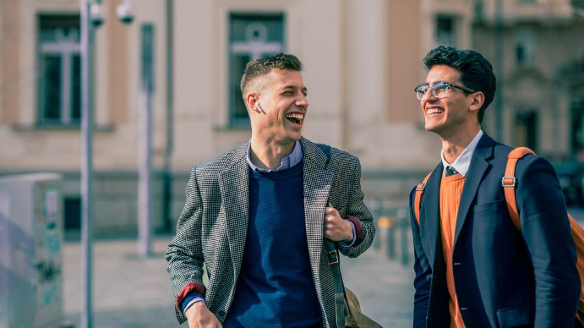 young men laughing outside building