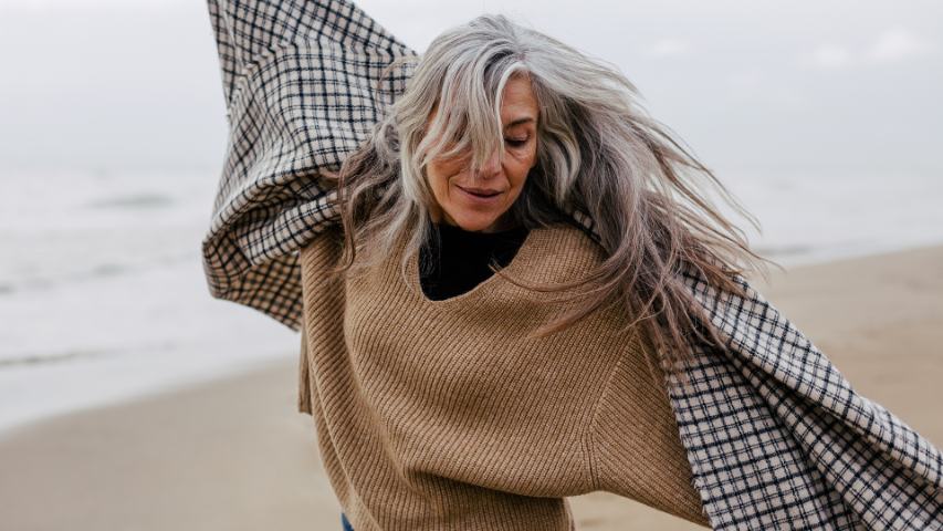 Senior woman enjoying a winter day on the beach.