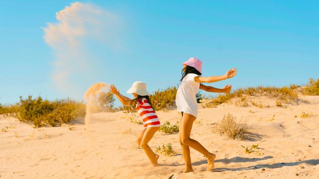 young girls playing on the beach