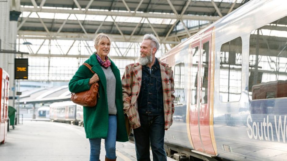 mature couple enjoying time together on a train station platform