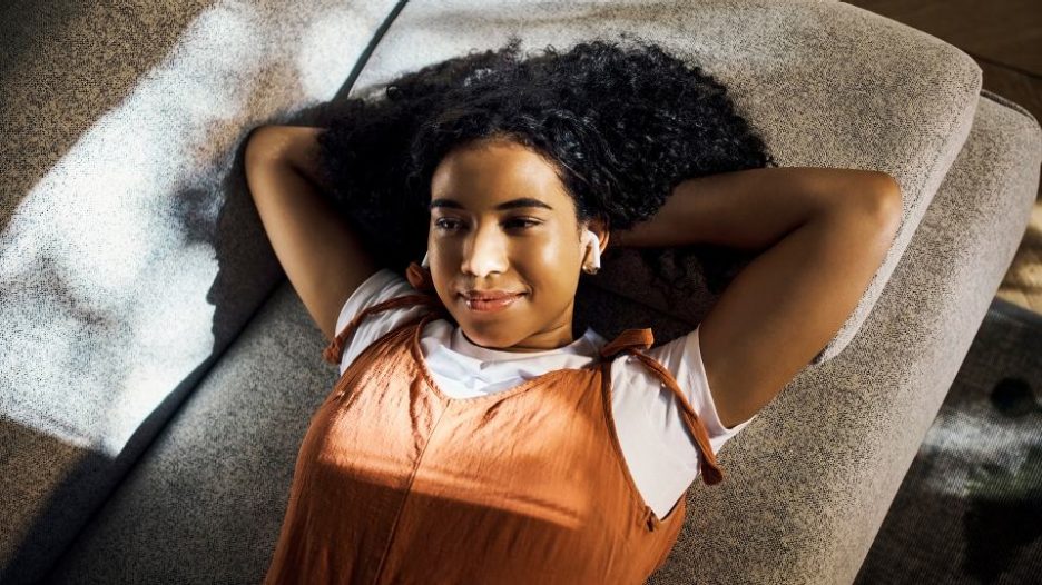 young woman relaxing on the floor while listening to music