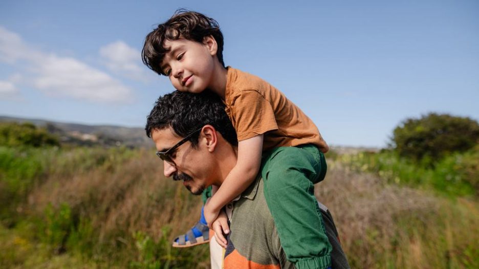 father carrying his young son