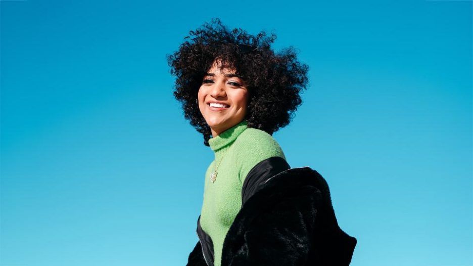 woman smiling with blue sky in background