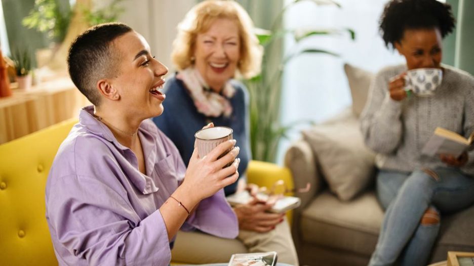 three women enjoying their time and drinking coffee at book club in a modern home