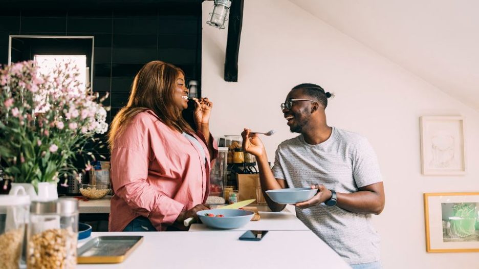 young african couple enjoying breakfast in their home