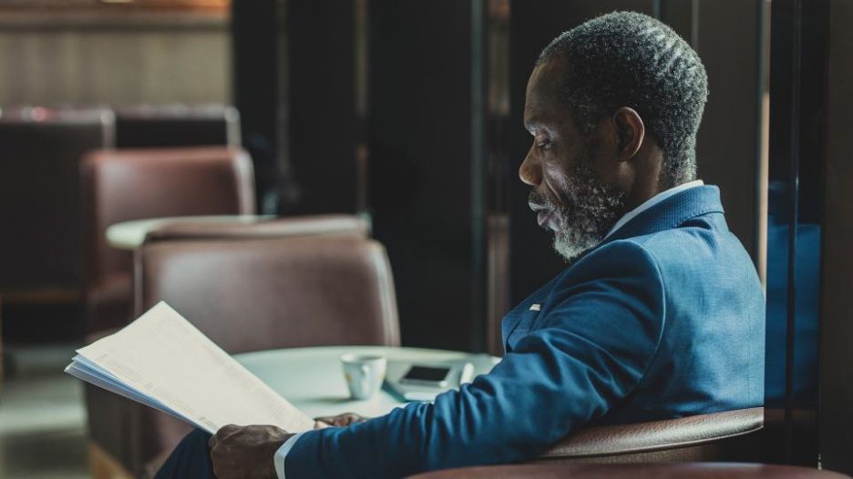 professional businessman enjoying a quiet moment in a cafe with his papers, coffee and phone