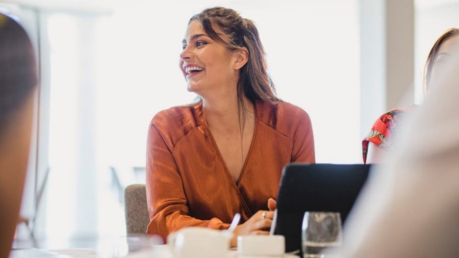 Female in office meeting smiling and laughing