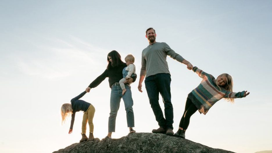 Family of five enjoying views from hill top