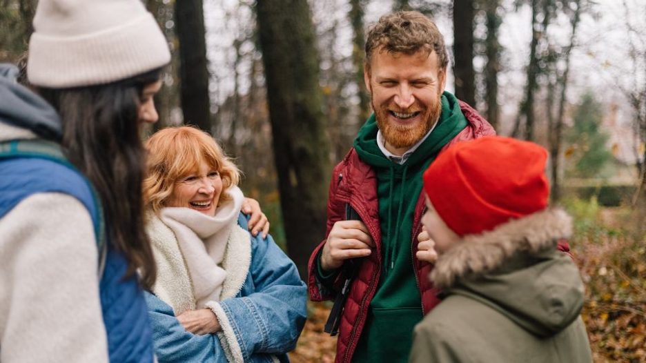 Family of five enjoying views from hill top